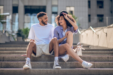 Two young people having fun together and looking joyful