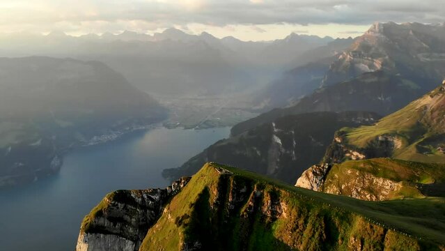 Spinning flyover around the summit of Niederbauen Chulm on a golden summer morning in the Swiss Alps with a view of the fjords of Lake Lucerne, Mythen, Rigi, Burgenstock, Pilatus  (sped up 4x)