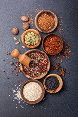 Different spices or seasonings in wooden bowls for tasty meals