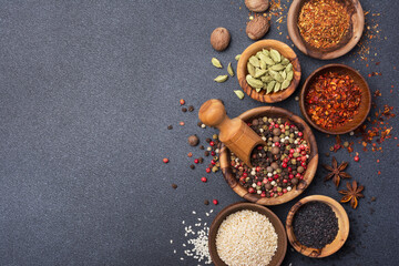 Different spices or seasonings in wooden bowls for tasty meals