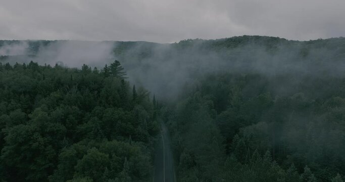 Drone flying through a beautiful foggy mountain top landscape. Straight and up. Professional and cinematic 4k footage. Dji Mavic 3