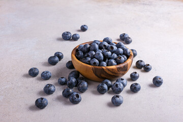 Fresh blueberry berries in wooden bowl