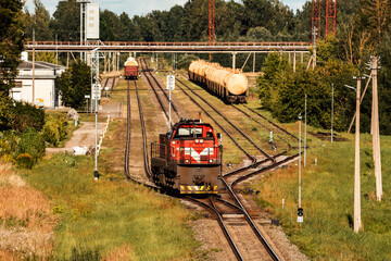 Lone shunting locomotive in red color at marshalling yard - obrazy, fototapety, plakaty