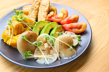A Plate of Grilled Oyster Mushrooms and Colorful Vegetables Salad Garnished with Daikon Microgreens