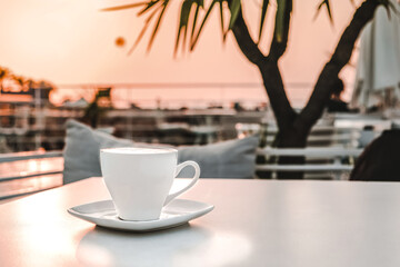 cup of coffee on a table in a cafe at dawn.Morning relaxation,meditation.Slow life.Coffee day
