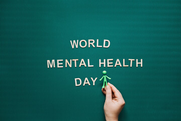 World Mental health day every year on October 10. World Mental Health Day Green Background with wooden words. A mental illness awareness