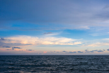 Naklejka na ściany i meble seascape with sunset against blue sky