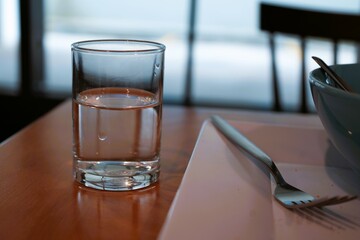 A drinking glass with half a glass of water