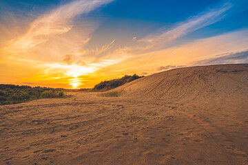 Fototapeta na wymiar Colorful sunset over an abandoned sand pit
