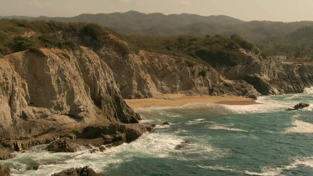 Rugged Cliffs At The Serene Beach Of Faro de Bucer&iacute;as, Playa Maroma In Michoacan, Mexico. Aerial Drone Shot