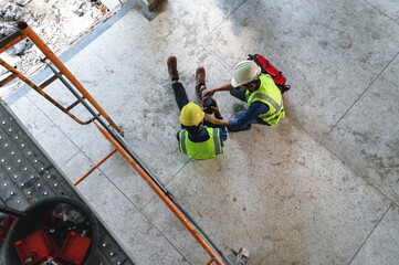 First aid support accident at work of builder worker in construction site. Accident falls from the...
