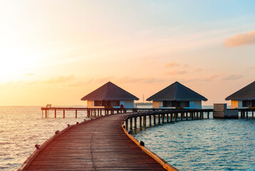 Fototapeta na wymiar picturesque view of the water villas at sunrise in the Maldives, the concept of luxury travel