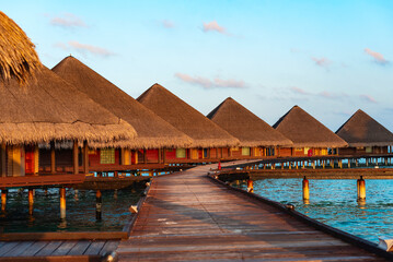 picturesque view of the water villas at sunrise in the Maldives, the concept of luxury travel