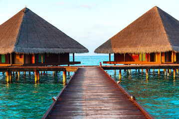 picturesque view of the water villas at sunrise in the Maldives, the concept of luxury travel