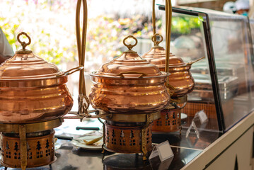 large copper kettles of food on the buffet in the Maldives, traditional Indian cuisine