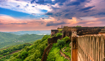 Fototapeta Sunset View of Jaigarh Fort, situated on the promontory called the Cheel ka Teela (Hill of Eagles) of the Aravalli range; it overlooks the Amer Fort and the Maota Lake, in Jaipur, Rajasthan, India  obraz