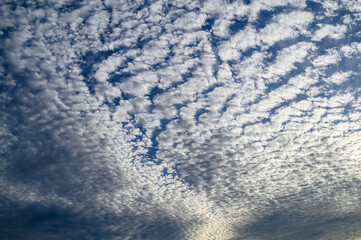 Dramatic blue sky with white clouds.