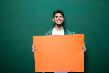 Pakistani, Indian, South Asian cricket fan holding play card in happy mood