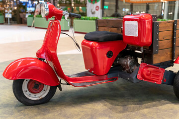 vintage old three-wheeled cargo scooter with wooden body