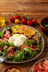 Salad with burrata cheese and croutons.