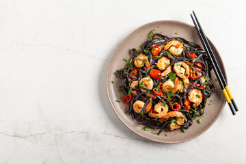 Black pasta with roasted prawns.