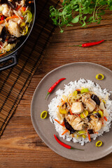 Chinese style cod, served on a plate with white rice.