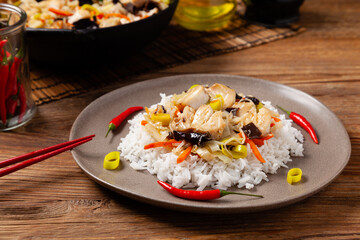 Chinese style cod, served on a plate with white rice.
