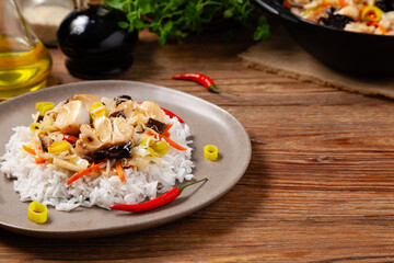 Chinese style cod, served on a plate with white rice.