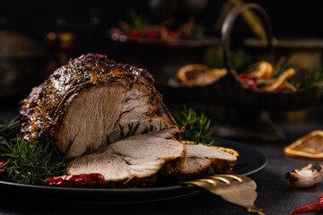 Whole roast pork neck. Christmas decoration. Dark background.