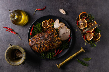 Whole roast pork neck. Christmas decoration. Dark background.