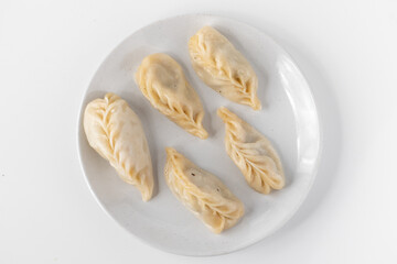 Traditional Dumpling Momos Served on white plate.