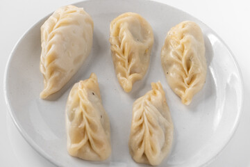 Traditional Dumpling Momos Served on white plate.