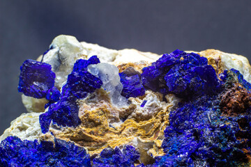 Macro blue azurite cluster on white matrix isolated crystal on black background 