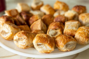 Homemade Savoury sausage rolls served on a plate. 