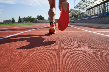 Athlete runner feet running on treadmill closeup on shoe
