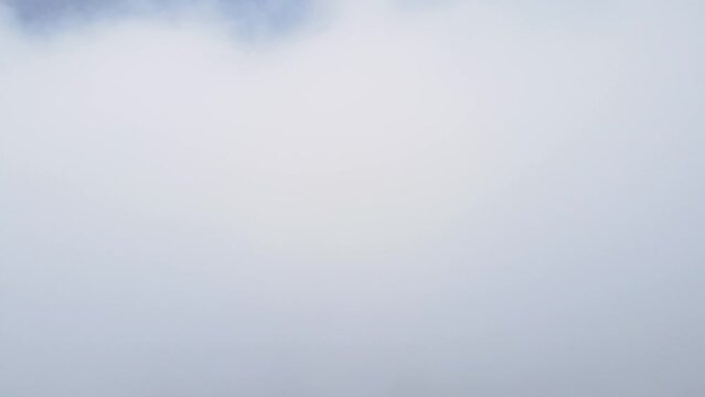 Fly in clouds to top of sky and mountain view behide 