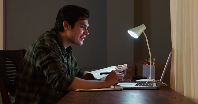 Young boy studying online using his laptop at home