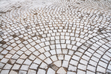 Square stone for paving the surface of the walkway.