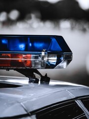 Vertical closeup of a police car emergency light siren © Shots By Daz/Wirestock Creators