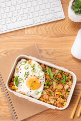Shrimp fried rice with vegetables and fried egg in a lunch box