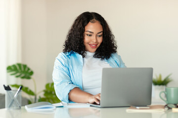 Black Businesswoman Using Laptop Working Online Sitting In Modern Office