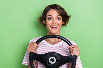 Photo of positive joyful pretty lady drive own car vehicle first lesson course test nice repaired road isolated on green color background