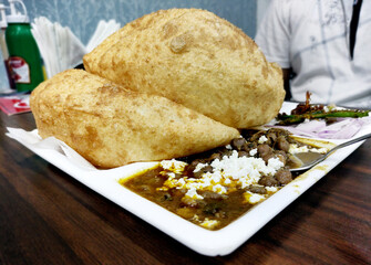 Chole Bhature: Indian dish spicy Chick Peas curry also known as Chole or Chana Masala is traditional North Indian main course recipe and usually served with fried puri / Bhature