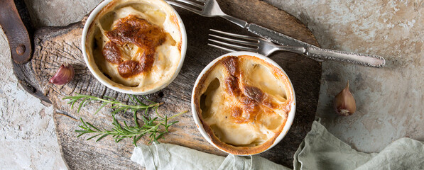 ramekins with traditional french potato gratin on the table