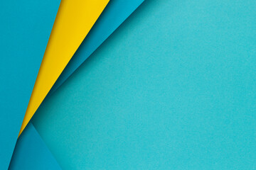 Abstract color papers geometry flat lay composition background with light blue and yellow tones. Top view