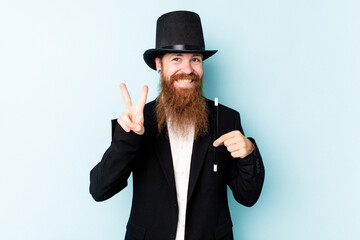 Young magician man isolated on blue background showing number two with fingers.