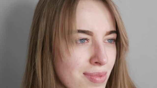 Young girl with blue eyes without makeup posing for the camera