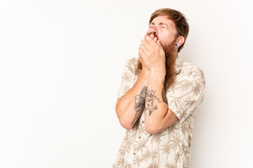 Young caucasian red-haired man isolated on white background thoughtful looking to a copy space covering mouth with hand.