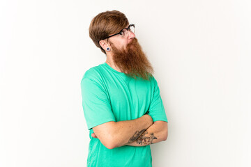 Young caucasian red-haired man isolated on white background dreaming of achieving goals and purposes