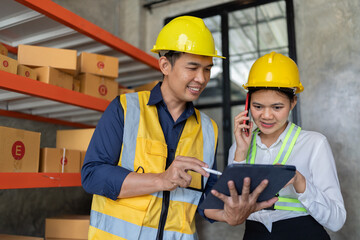 Male and Female warehouse workers discussing shipping schedule next to the forklift. Warehouse and...
